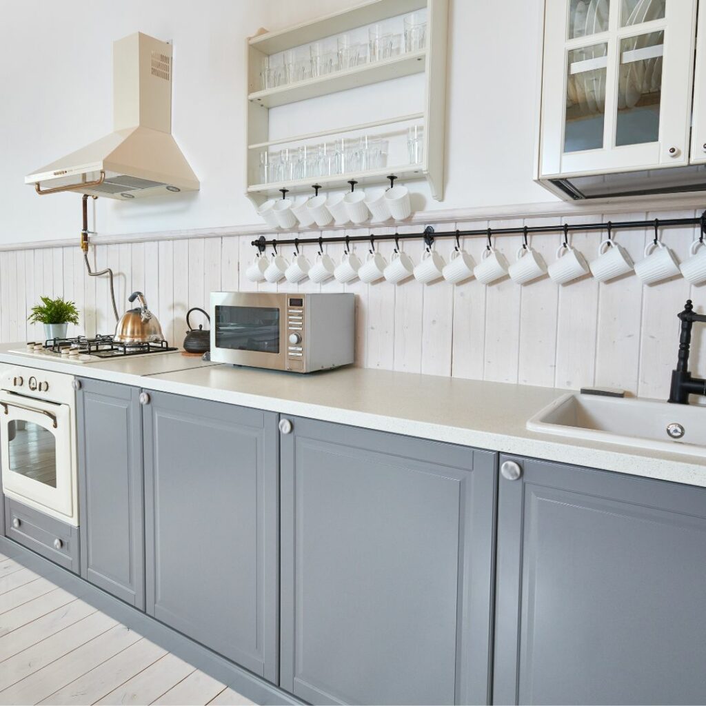 grey kitchen cabinets vinyl wrapped in a white Dubai kitchen