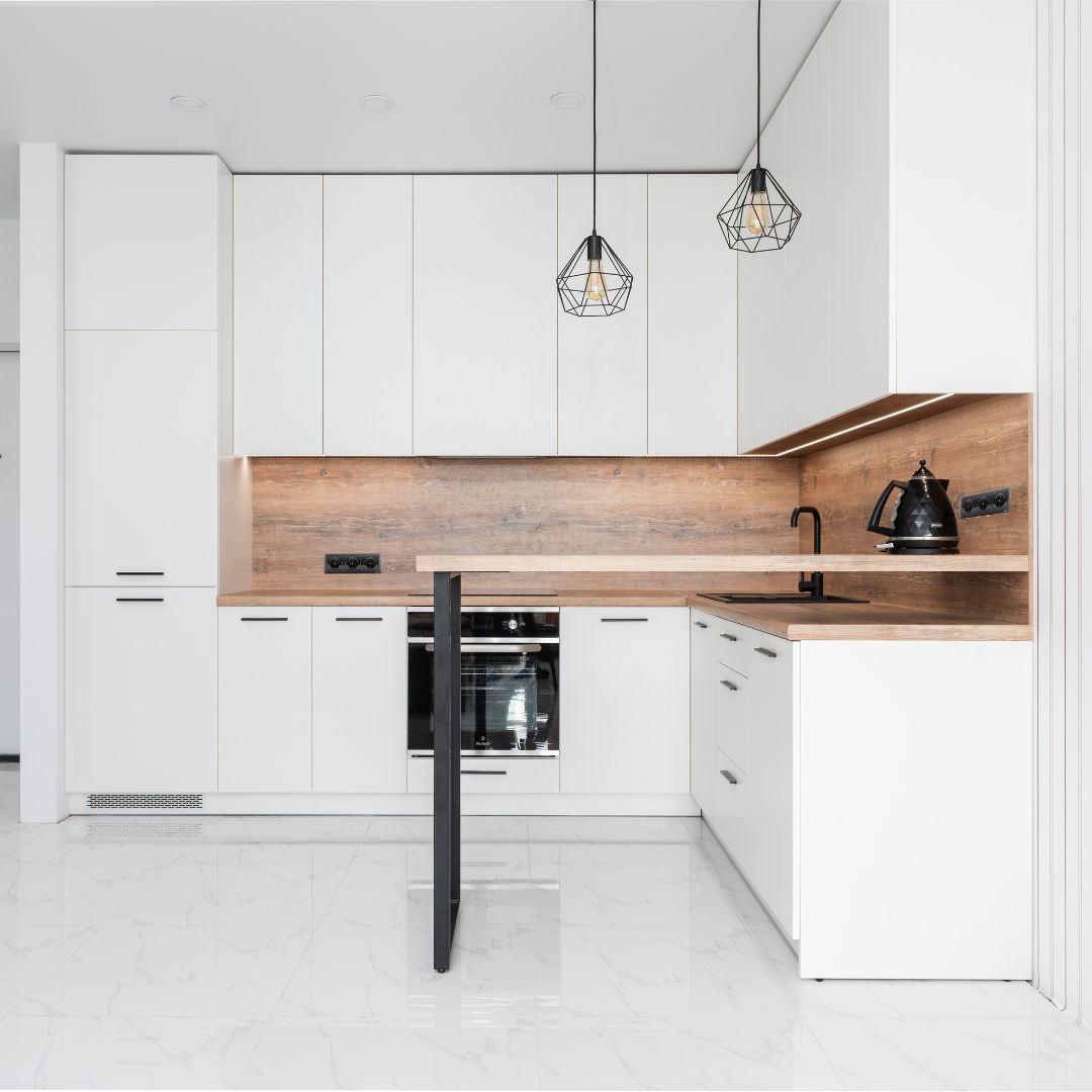 high gloss white vinyl wrapped kitchen cabinets in Dubai apartment kitchen